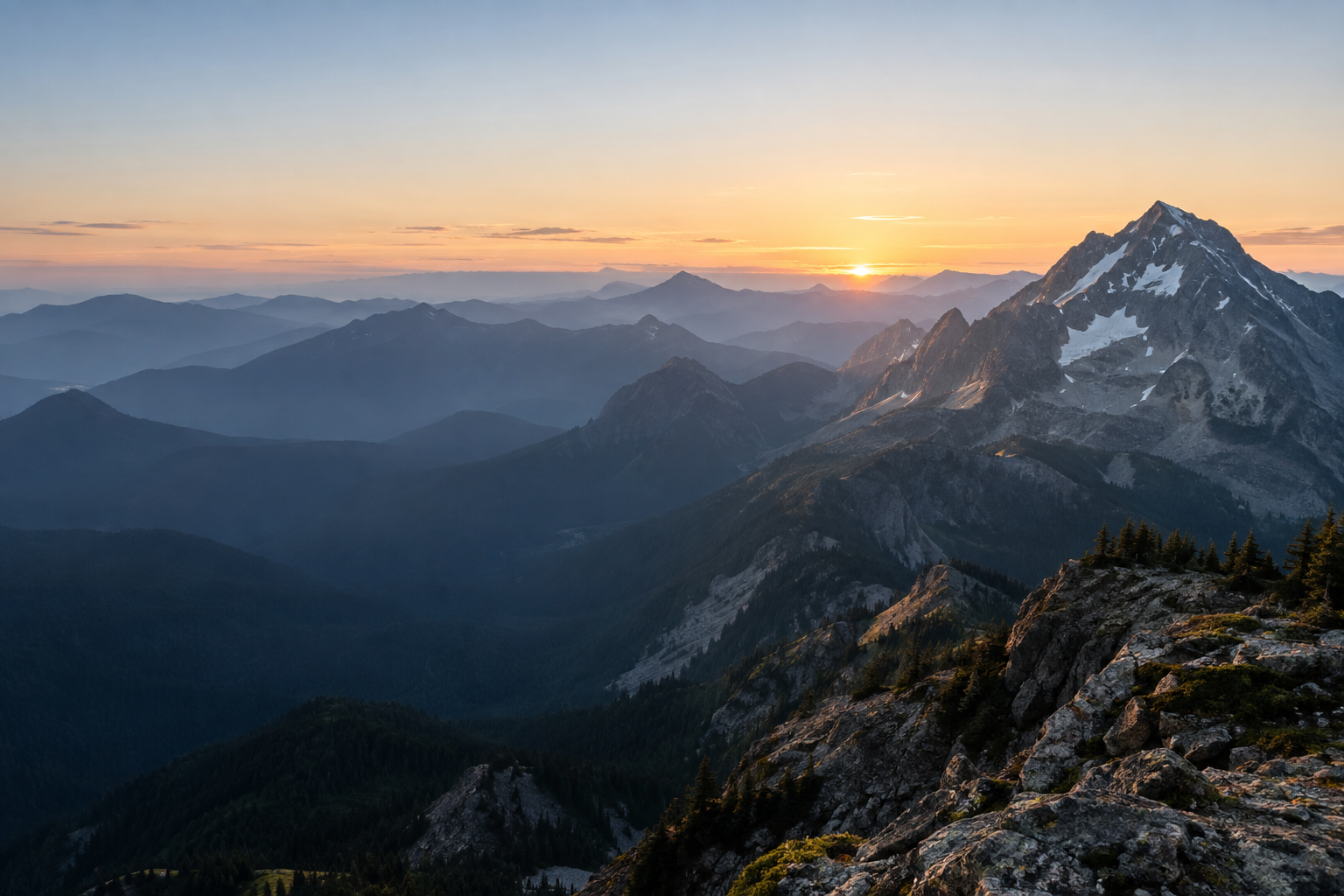 Layered mountain ridges opening toward a bright horizon